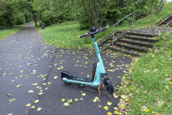 E-scooter of bike rental company TIER parked on pavement