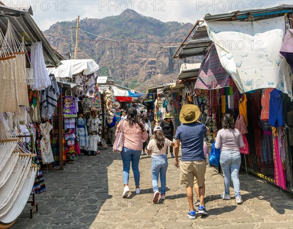 People walking past stalls in the market