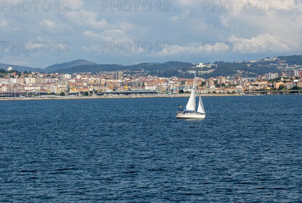 Small boat sailing in estuary of Ria de Vigo