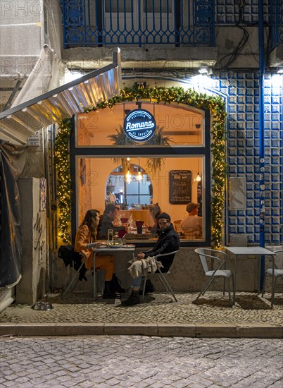 Outdoor restaurant in Alfama by night