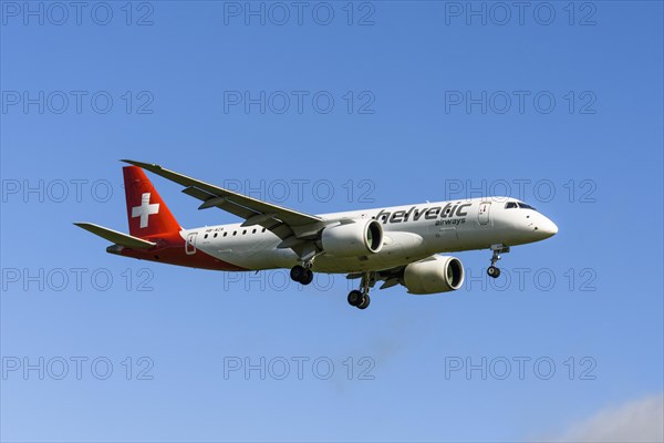 Helvetic Airways passenger aircraft Embraer E190-E2 on approach to Zurich airport