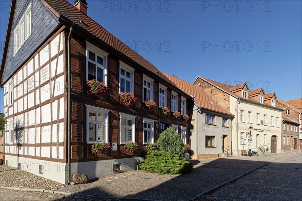 Half-timbered house decorated with flower boxes in the cobbled Lange Strasse in the Hanseatic town of Werben in the Altmark region. Werben