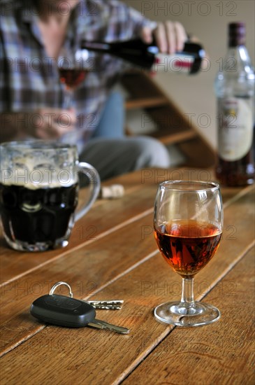 Car key and man pouring alcohol