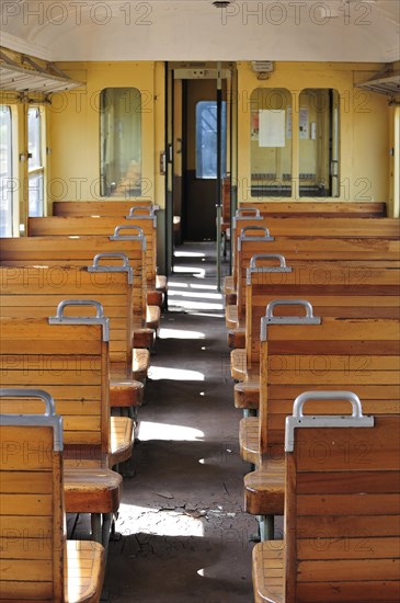 Old passenger carriage with wooden benches at the depot of the Chemin de Fer a Vapeur des Trois Vallees at Mariembourg