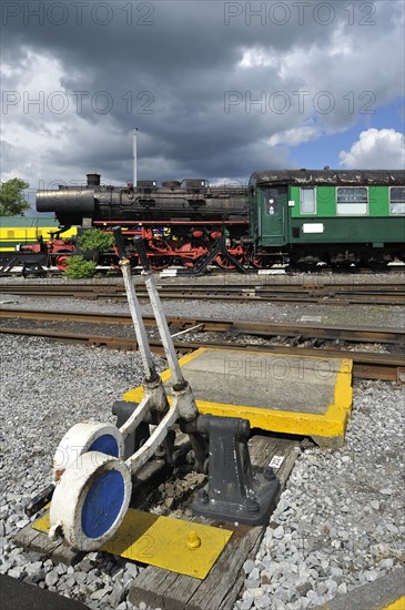 Steam train and track switch levers at the depot of the Chemin de Fer a Vapeur des Trois Vallees at Mariembourg