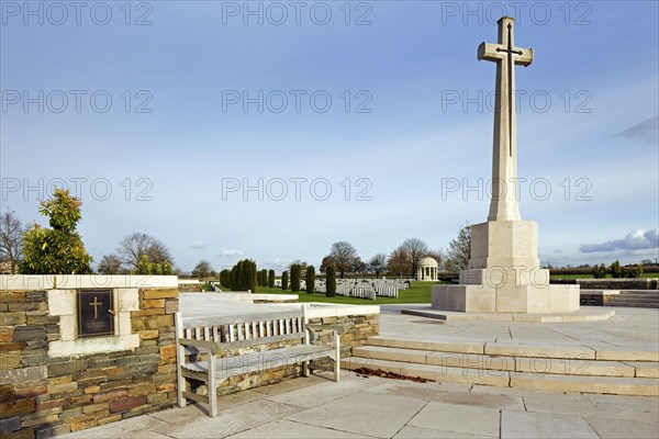 Cross of Sacrifice at the Bedford House cemetery with graves of First World War British Empire soldiers at Zillebeke near Ypres