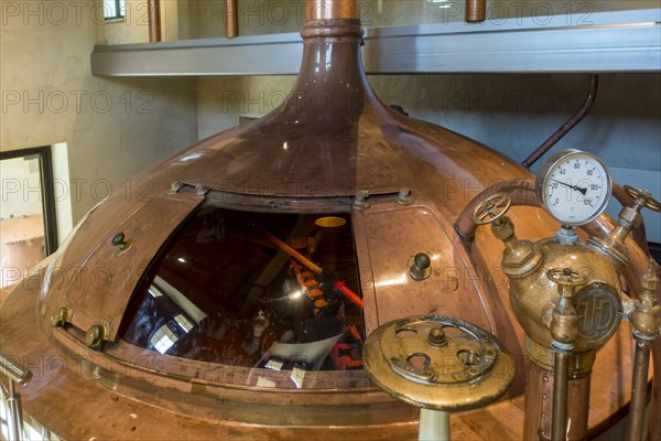 Gauge and valves on copper kettle of Trappist beer brewery in the Orval Abbey