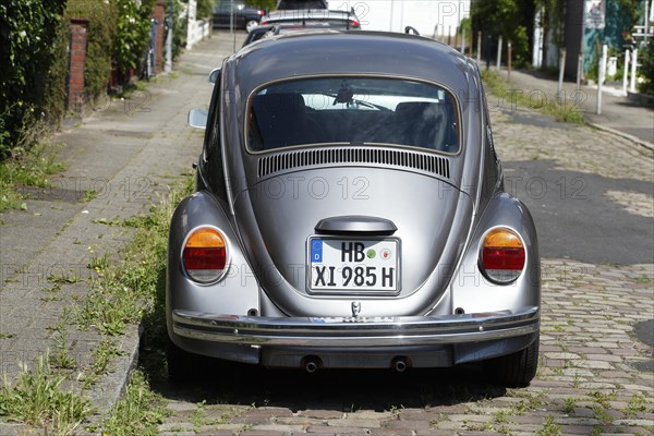 Silver VW Beetle parked on the street