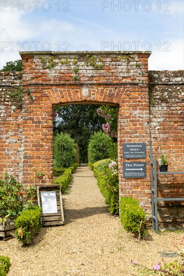 Red brick entrance to walled kitchen garden