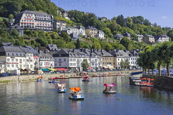 Paddle boats with tourists on the Semois river in the city Bouillon in summer