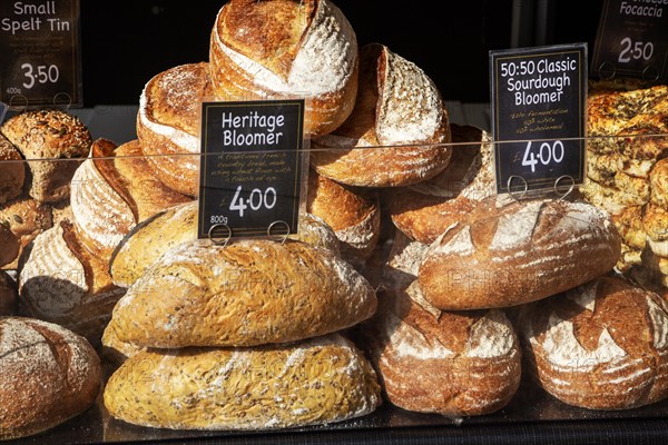 Fresh loaves of artisan bread on sale at street market stall
