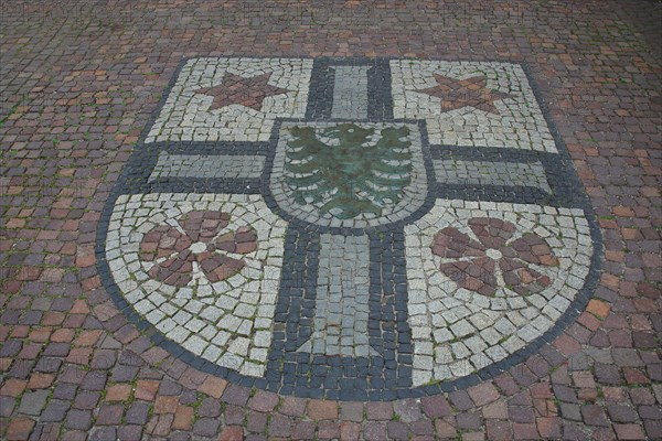 City coat of arms as a floor mosaic in front of the town hall