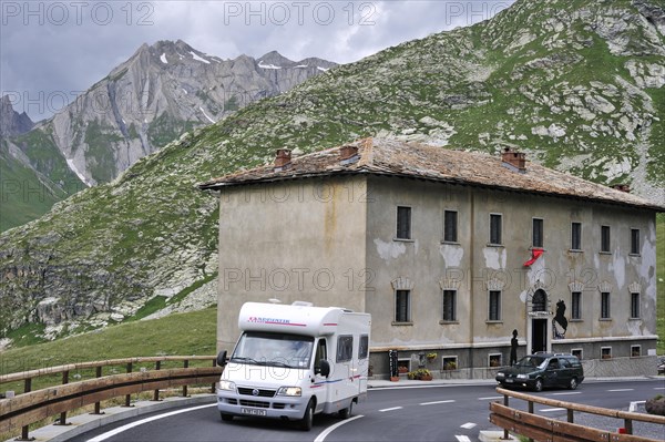 Tourist cars driving past the hospice Fonteinte at the Great Saint Bernard Pass