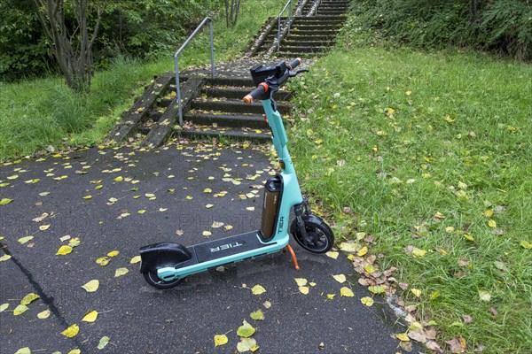 E-scooter of bike rental company TIER parked on pavement