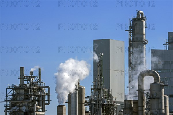 Smoke from chimneys at industrial estate showing BASF chemical production site in the port of Antwerp