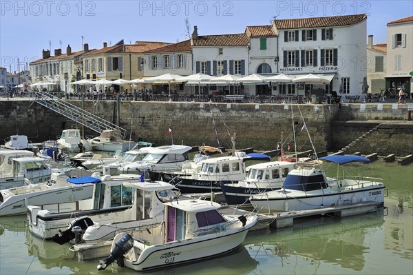 Pleasure boats and restaurants in the harbour at Saint-Martin-de-Re on the island Ile de Re