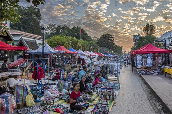 Night market with stalls selling colourful clothes