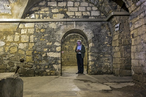 Elderly tourist with audio guide visiting First World War One Fort de Douaumont