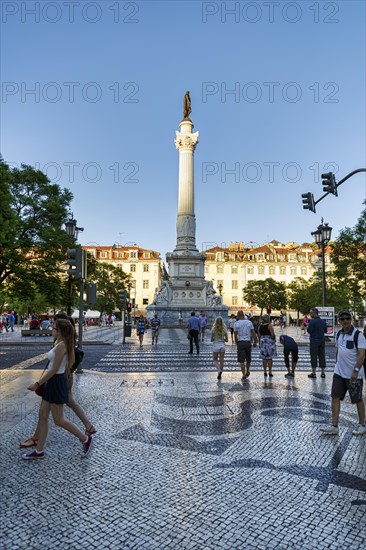 Pedestrian in front of statue of Pedro IV