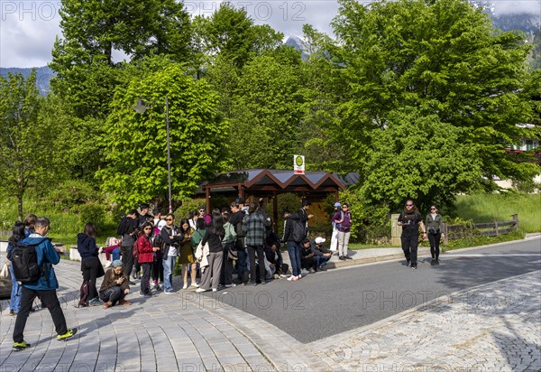 Group of tourists standing at a bus stop in Schoenau