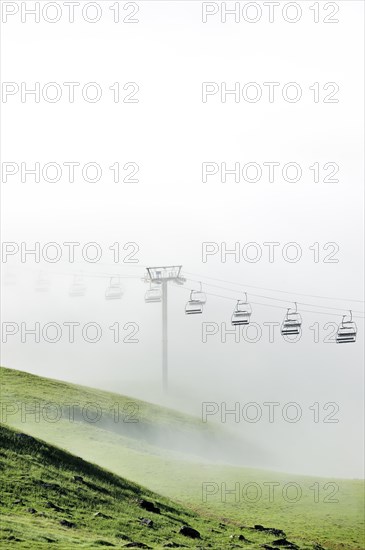 Chairlift in the mist at sunrise along the Col du Tourmalet in the Pyrenees