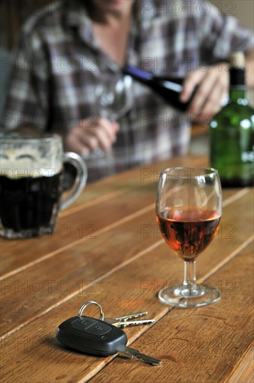 Car key and man pouring alcohol