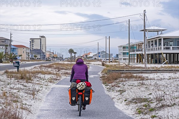 Touring cyclist cycling along bicycle path