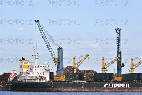 Bulk carrier loading recycled scrap metal in dock at Ghent seaport