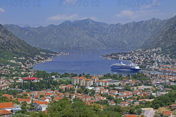 View over the city Kotor and cruise ship moored in the Mediterranean port on the Bay of Kotor