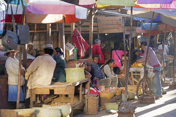 Malagasy street vendors selling fruit and vegetables on daily market in the city Antsirabe