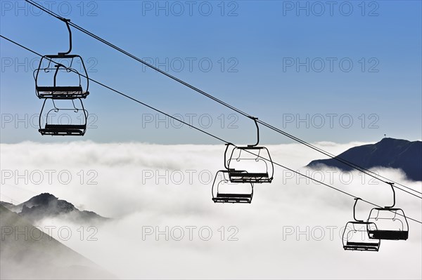 Empty chairlift in the mist at sunrise along the Col du Tourmalet in the Pyrenees