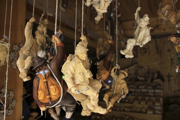 Woodcarving figures of wooden mountaineers in souvenir shop of woodcutter