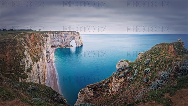 Idyllic panorama of Porte d'Aval natural arch at Etretat famous cliffs washed by Atlantic ocean