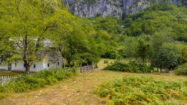 Beautiful wooden cabin under the Grunas waterfall in Theth National Park