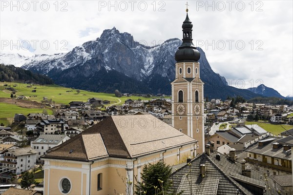 Village and snow-capped mountains