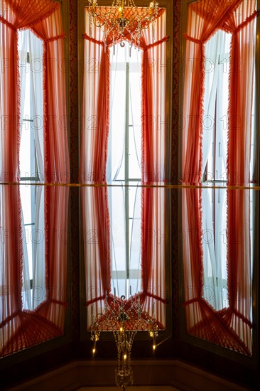 Beautiful Windows with Curtains and Crystal Lamp and Reflection in Switzerland