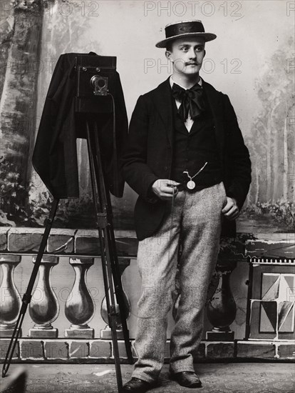 Full-length self-portrait of the photographer Emile Schall in his studio in Nancy