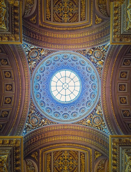 View underneath the glass dome and golden ornate ceiling