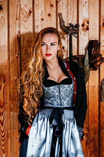 Woman in dirndl with cardigan and long hair