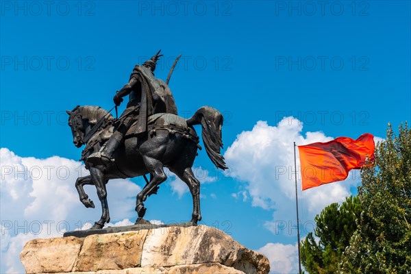 Skanderbeg horse monument at Skanderbeg Square in Tirana and the red flag of Albania