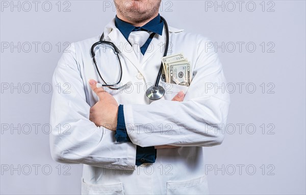 Medical bribery concept. Bribed doctor with money in pocket isolated. Corrupt doctor with bribe money in pocket isolated