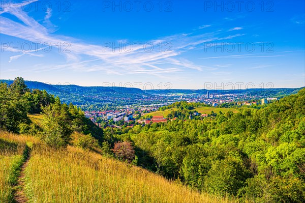 View over the city of Jena from the Galgenberg with the Kernberge in the background under blue sky and veil clouds