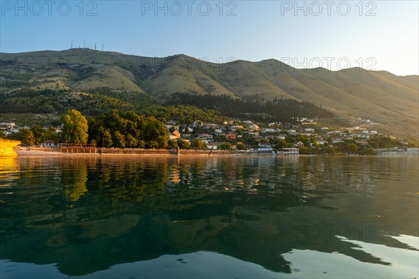 View of the city of Shiroka from the lake on a traditional boat on a sightseeing excursion from Shkoder. Albania