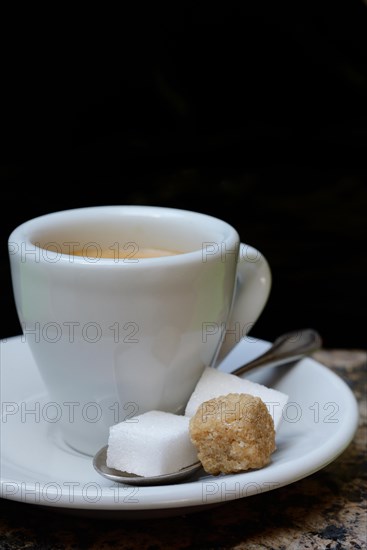 Espresso cup with white and brown sugar cubes