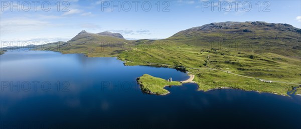 Aerial panorama of the freshwater loch Loch Assynt with the ruins of Ardvreck Castle on a peninsula