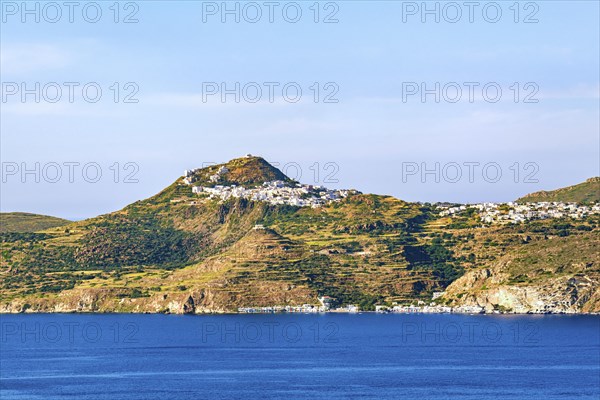 Beautiful view of Mediterranean island and its seashore. Whitewashed houses atop of high hills