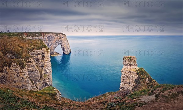 Beautiful view to the Porte d'Aval natural arch at Etretat famous cliffs in Normandy