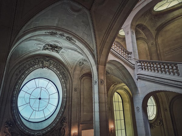 Louvre Palace architectural details of a hall with stone staircases