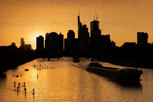 The sun shines through between the skyscrapers of Frankfurt's banking skyline shortly in front of setting