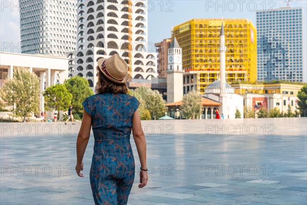 A tourist walking on vacation through Skanderbeg Square in Tirana. Albania